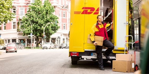 A parcel carrier delivers a package with DHL