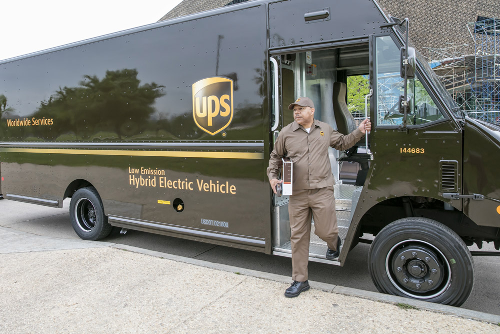 A UPS delivery vehicle and parcel delivery driver